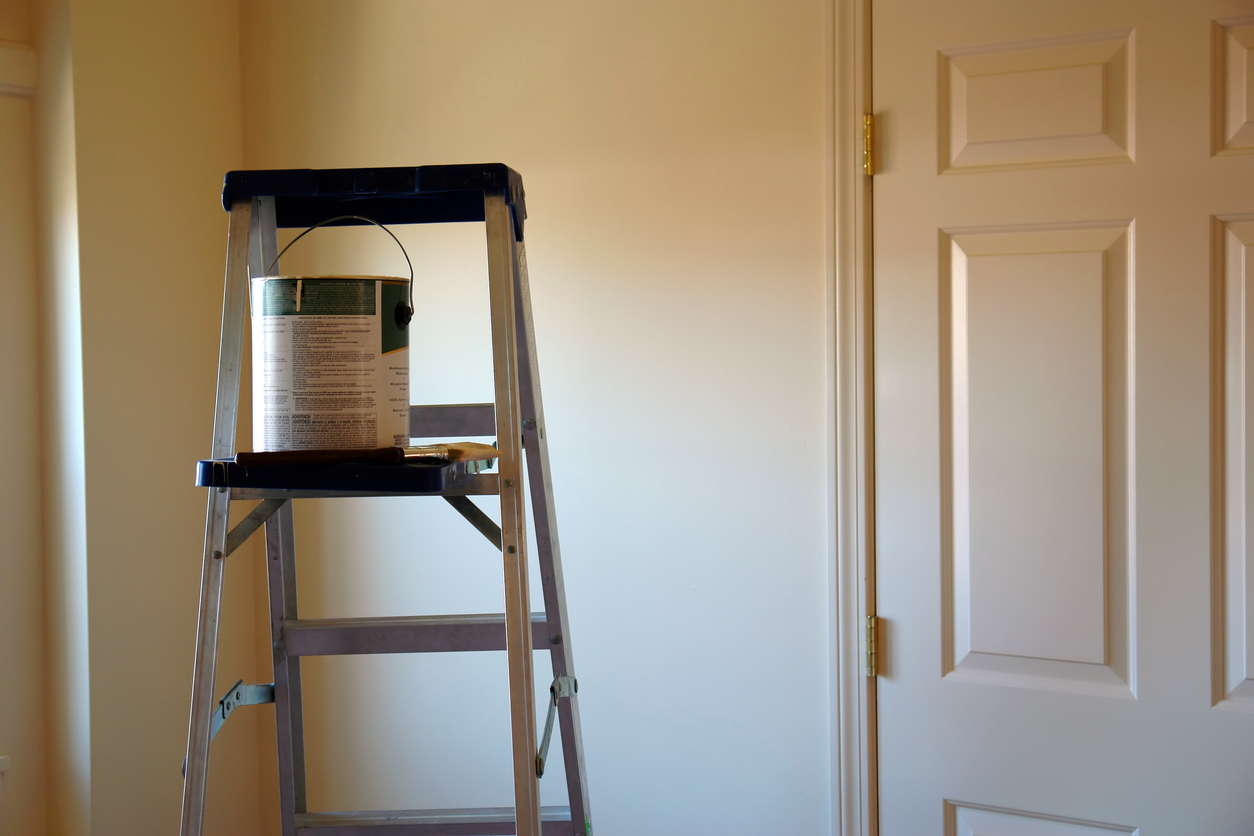 Ladder with paint can and brush